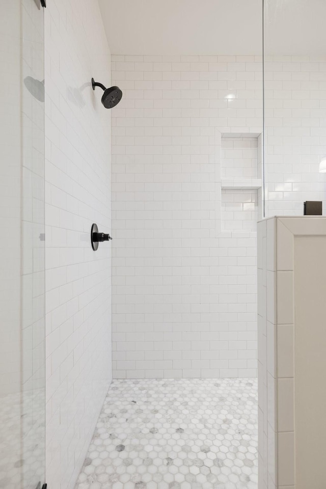 bathroom featuring a shower with door