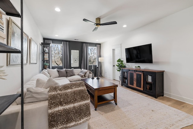 living room featuring ceiling fan and light wood-type flooring