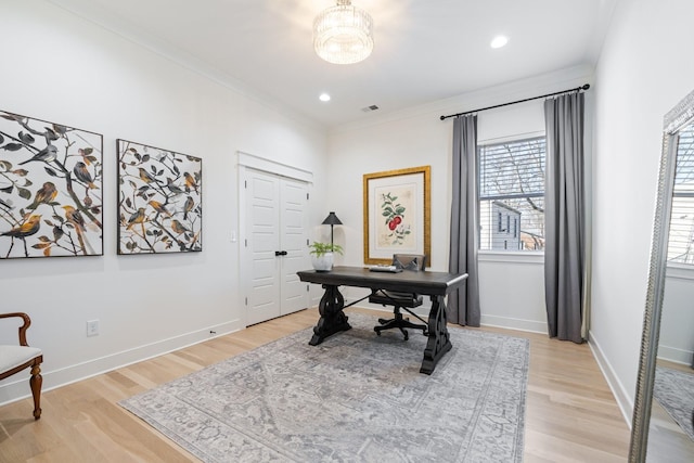 office area with light hardwood / wood-style flooring and ornamental molding