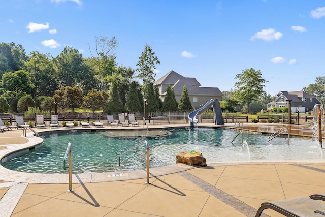 view of swimming pool featuring a patio, pool water feature, and a water slide