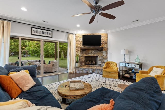 living room featuring a fireplace, ceiling fan, wood-type flooring, and crown molding