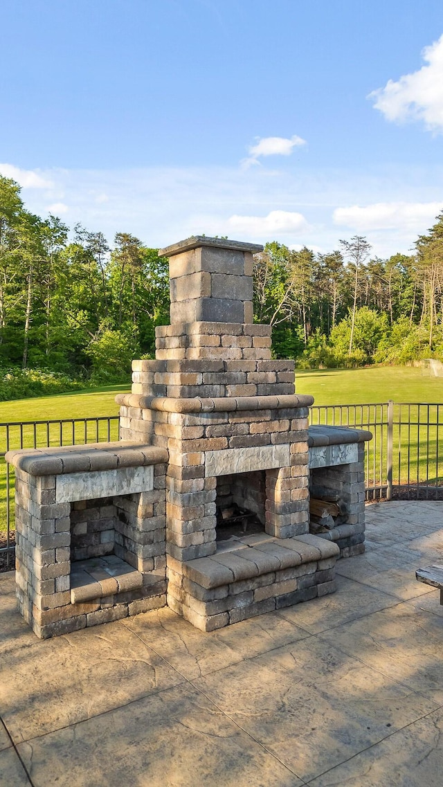 exterior space featuring an outdoor stone fireplace