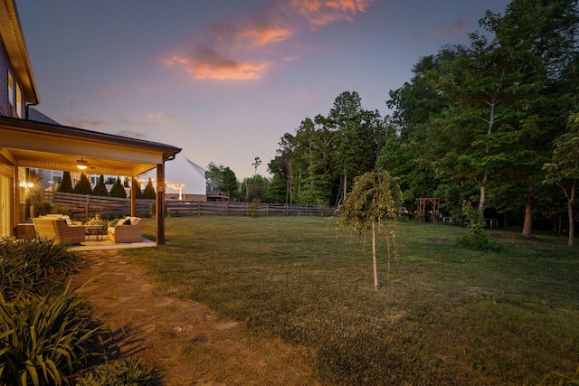 yard at dusk with a patio