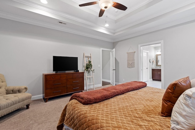 carpeted bedroom with ensuite bathroom, a raised ceiling, ceiling fan, and crown molding