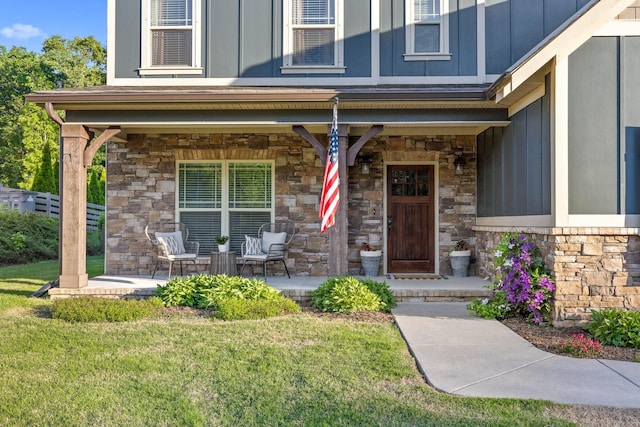 property entrance featuring a yard and covered porch