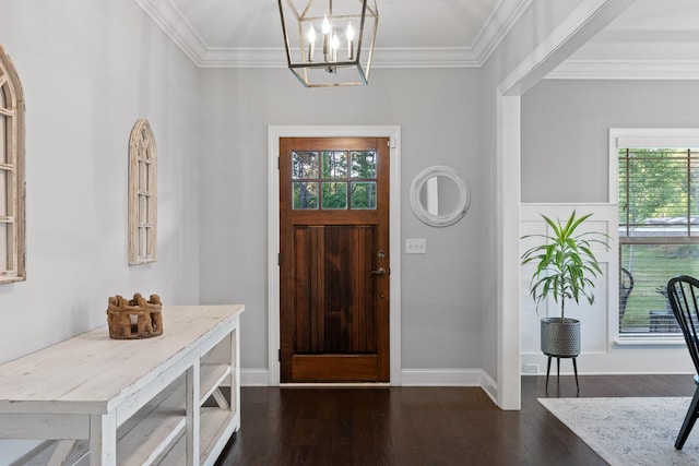 foyer featuring dark hardwood / wood-style flooring, crown molding, and a chandelier