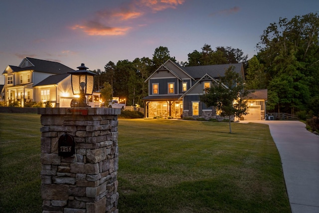 craftsman-style house featuring a yard and a garage