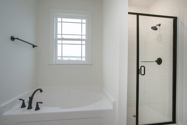 bathroom with shower with separate bathtub