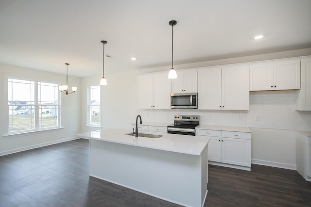 kitchen with white cabinetry, an island with sink, appliances with stainless steel finishes, and sink