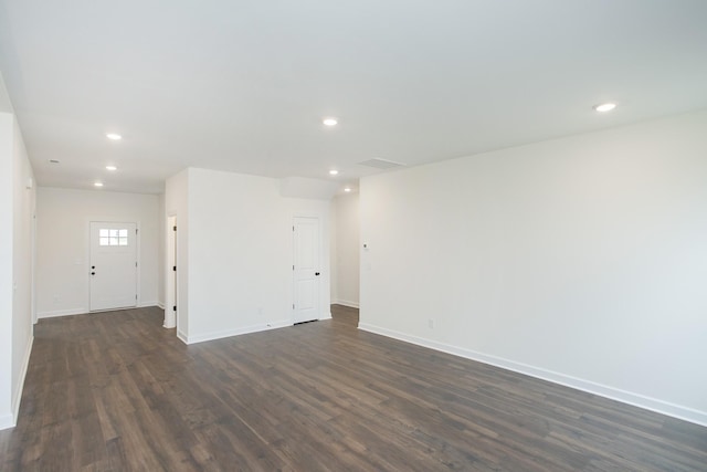 spare room featuring dark hardwood / wood-style floors