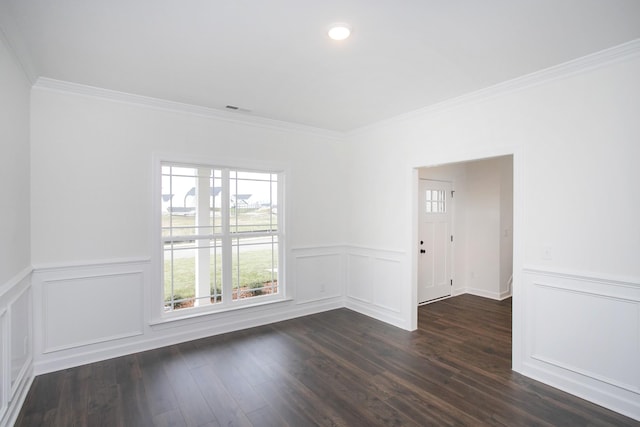 empty room with ornamental molding and dark wood-type flooring