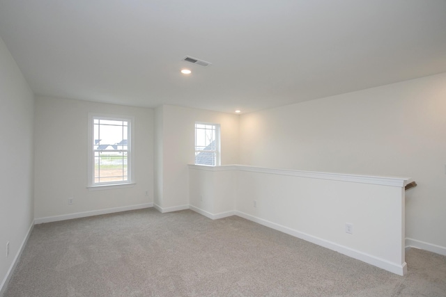 unfurnished room featuring light colored carpet