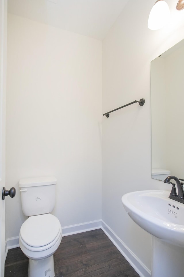 bathroom featuring hardwood / wood-style flooring, sink, and toilet