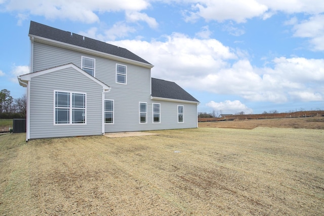 rear view of property with a lawn