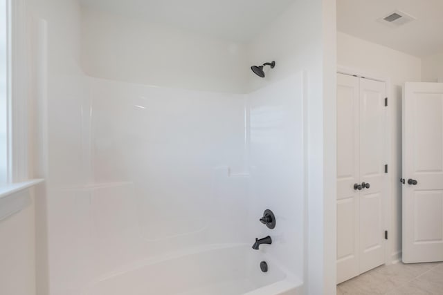 bathroom featuring tile patterned flooring and shower / washtub combination