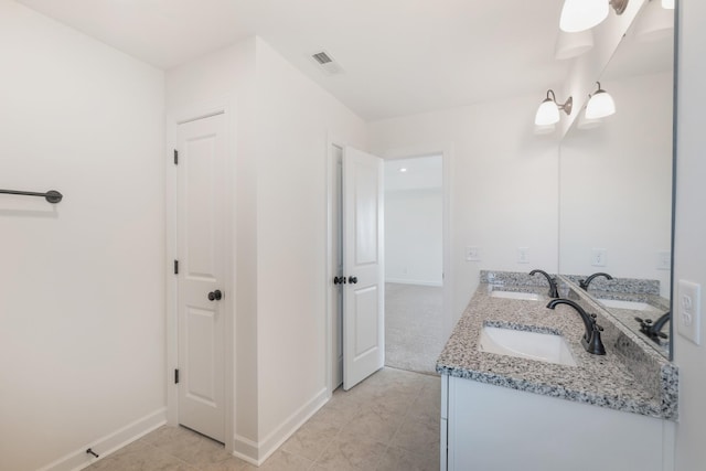 bathroom featuring tile patterned flooring and vanity