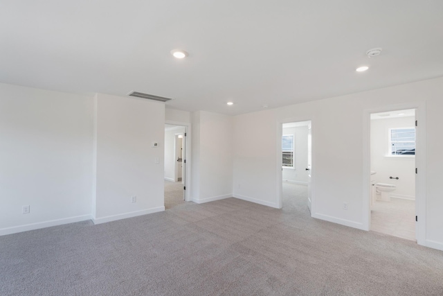 unfurnished room with light colored carpet