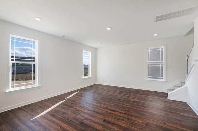 unfurnished room with dark hardwood / wood-style flooring