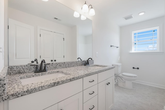 bathroom with tile patterned floors, vanity, and toilet