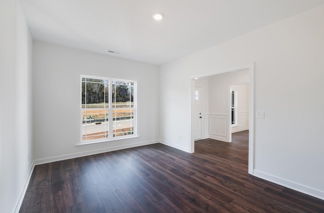 unfurnished room featuring dark hardwood / wood-style floors