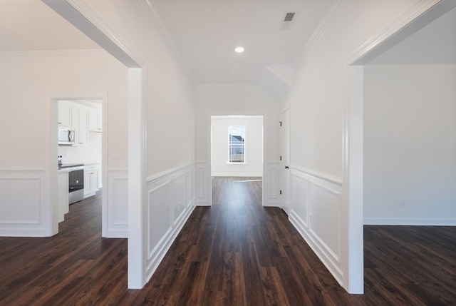 hallway with dark hardwood / wood-style floors and ornamental molding