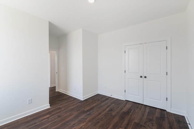 empty room featuring dark wood-type flooring