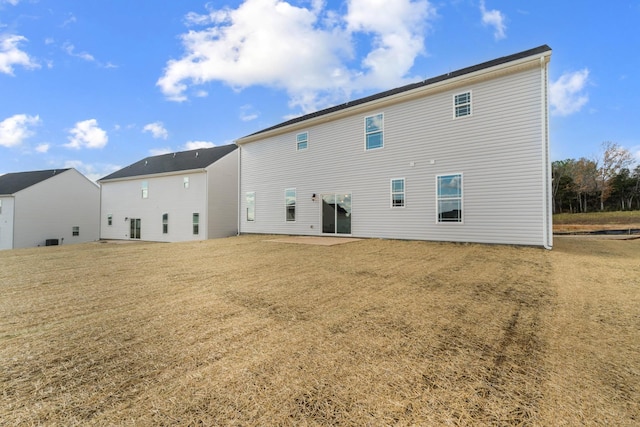 back of property featuring a patio area and a yard