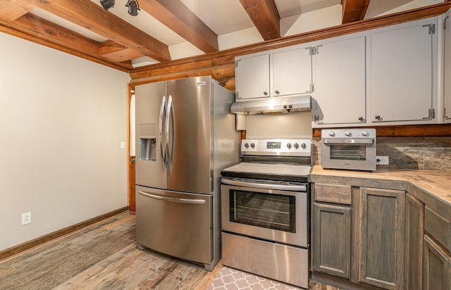 kitchen with light hardwood / wood-style flooring, beamed ceiling, and stainless steel appliances