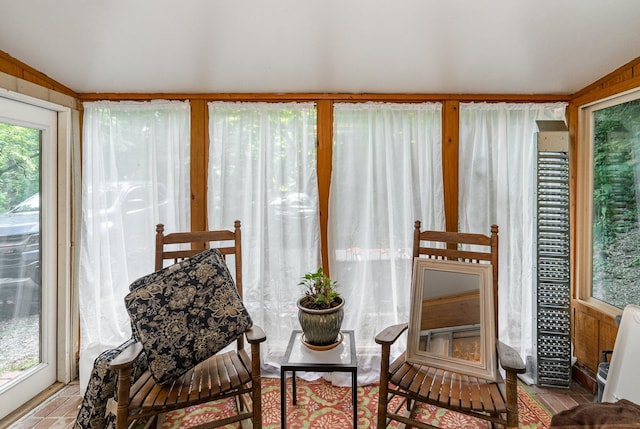 sunroom featuring lofted ceiling