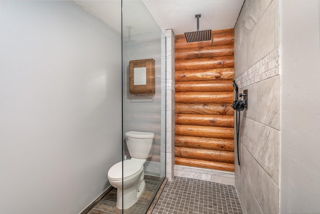 bathroom with walk in shower, log walls, and toilet