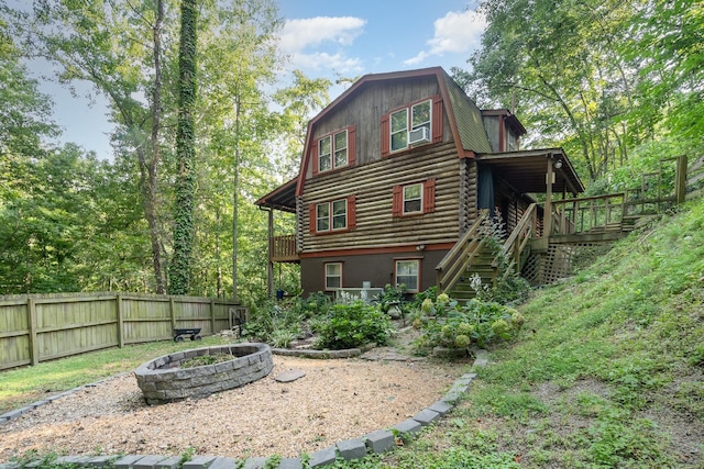 back of property featuring an outdoor fire pit