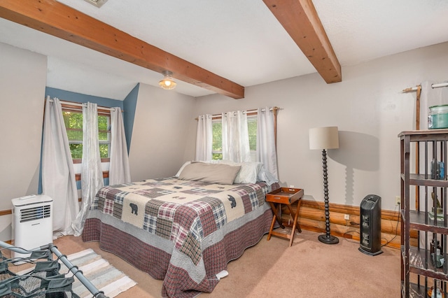 carpeted bedroom with beam ceiling