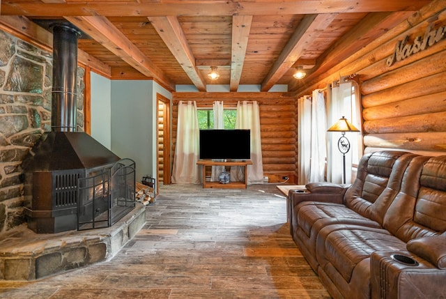 living room featuring wood ceiling, log walls, beamed ceiling, hardwood / wood-style floors, and a wood stove