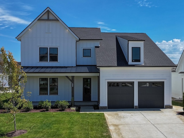 modern farmhouse style home with a front yard and a garage