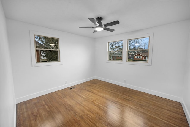 spare room with ceiling fan and hardwood / wood-style flooring