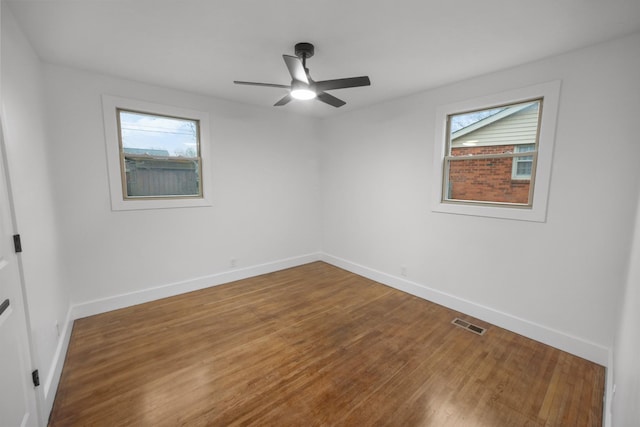 empty room with ceiling fan and wood-type flooring