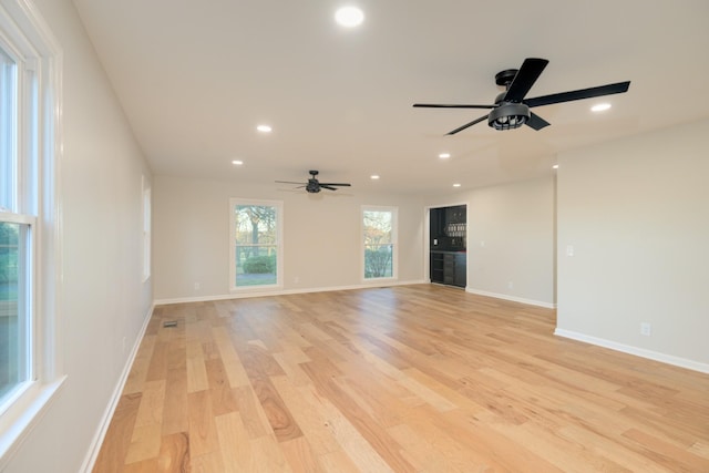 unfurnished living room featuring light hardwood / wood-style flooring and ceiling fan