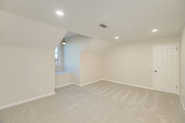 additional living space with lofted ceiling and light carpet