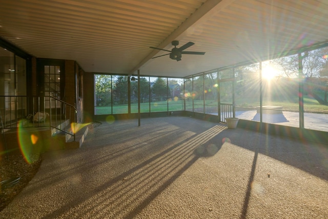 unfurnished sunroom featuring ceiling fan