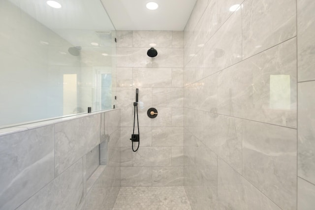 bathroom with a tile shower