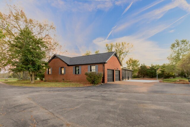 property exterior at dusk with a garage