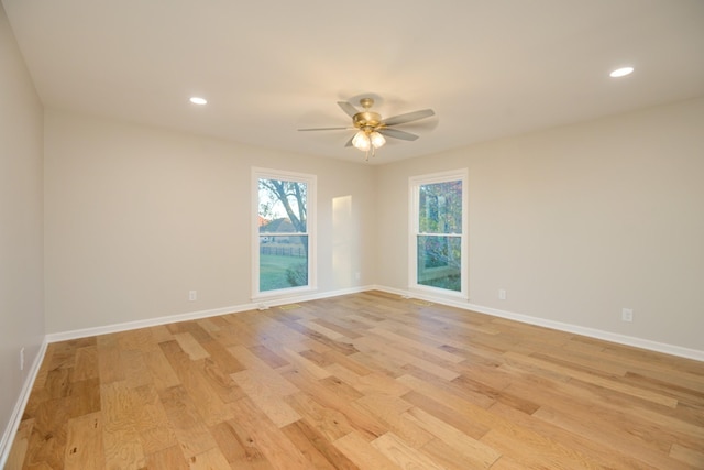 spare room featuring ceiling fan and light hardwood / wood-style floors