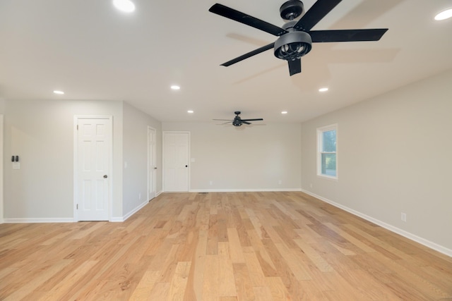 unfurnished room with ceiling fan and light wood-type flooring