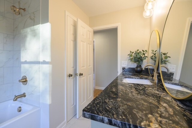 bathroom featuring vanity and tiled shower / bath combo