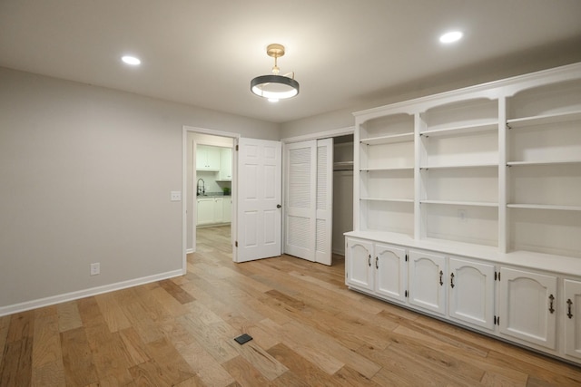 interior space with light hardwood / wood-style floors and sink