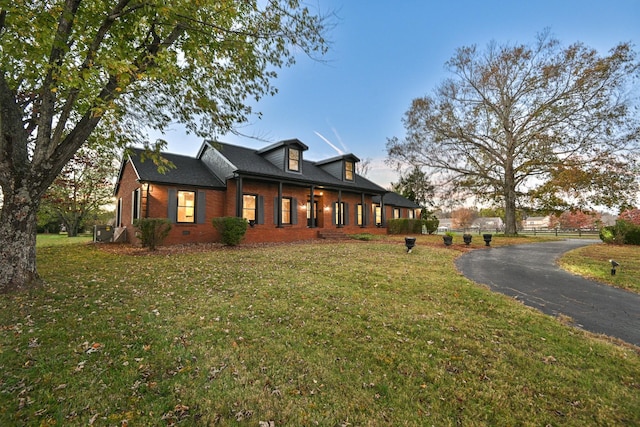 property exterior at dusk with a lawn