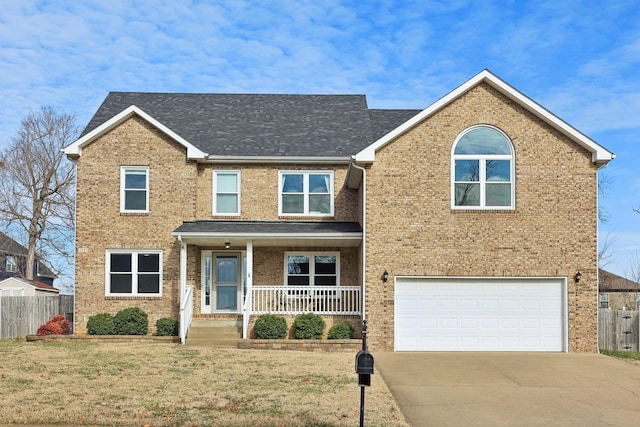 view of front of house with a front yard, a porch, and a garage