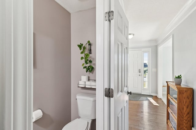 interior space with hardwood / wood-style floors and ornamental molding