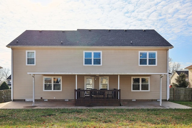 rear view of property with a patio and a lawn