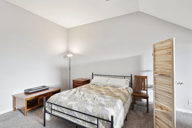 bedroom with carpet floors and lofted ceiling